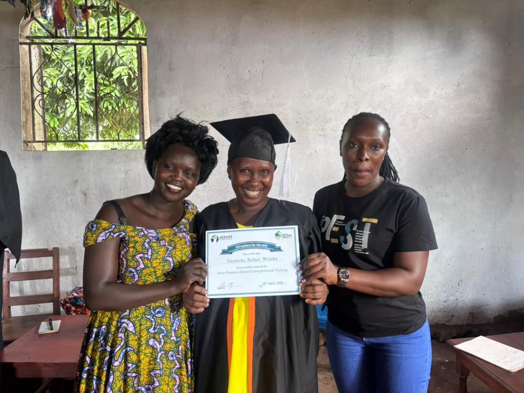 Florence Namakula holding her graduation certificate