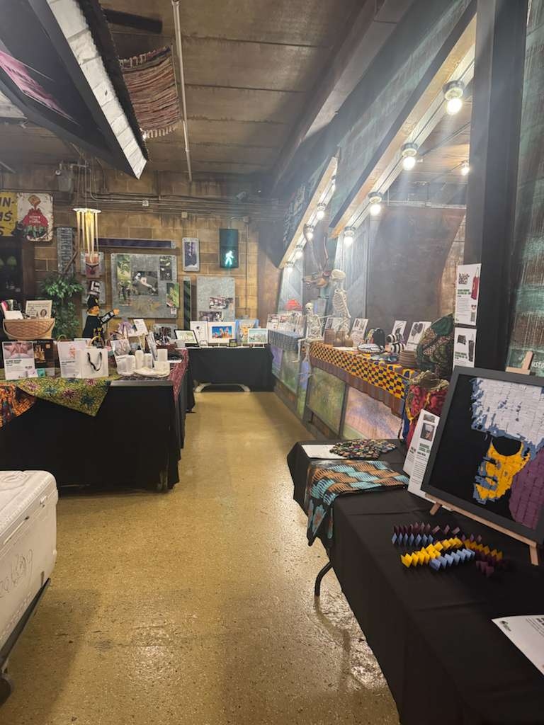 Bidding sheets and African crafts laid out beautifully on the silent auction tables