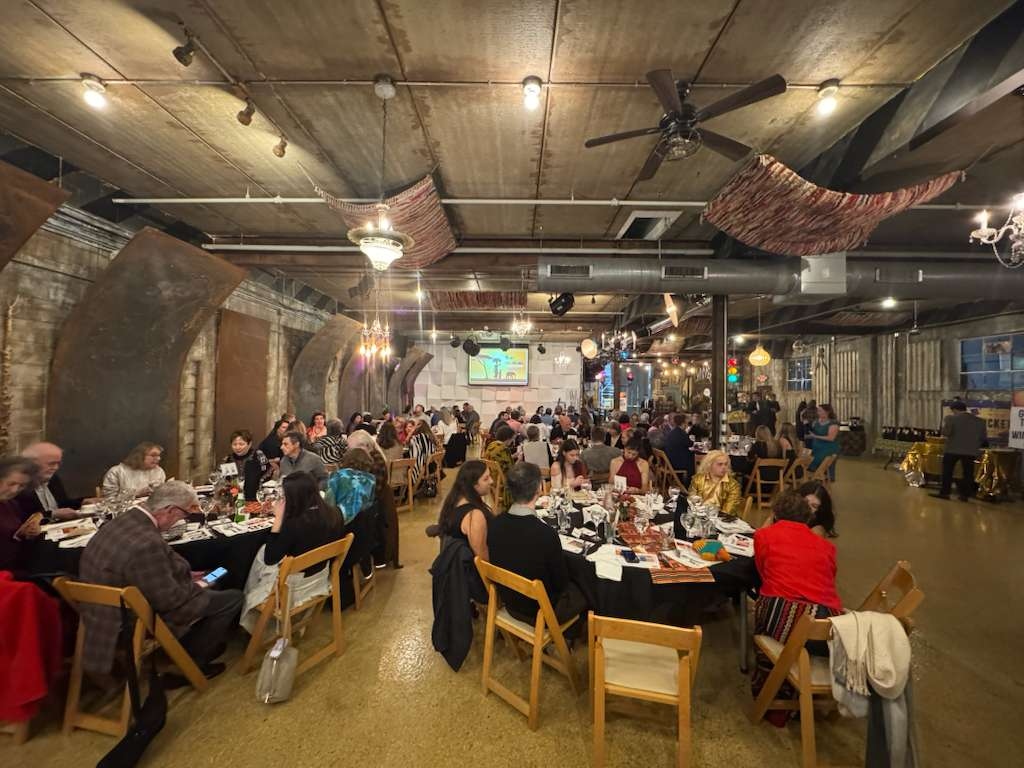 Guests seated at dinner enjoying the safari-themed evening program