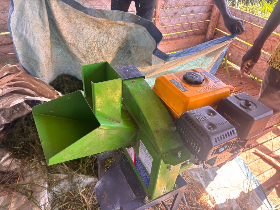 Close-up of the newly acquired green and yellow gas-powered feed cutter machine at Kwania Goat Farm