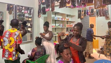 A busy day inside the newly established Namutumba Women's Salon facility with stylists and customers